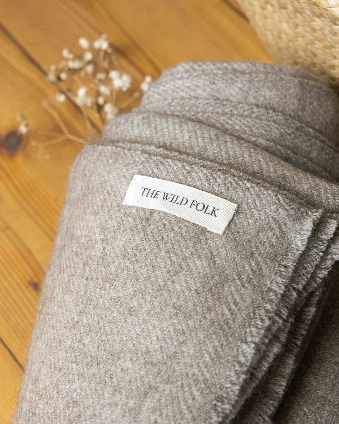Brandlabel von heWildFolk auf einer warmen Decke aus Yakwolle.