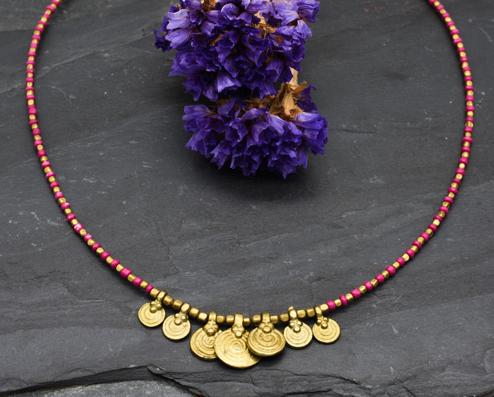 Spiral necklace with red pearls | Brass & glass